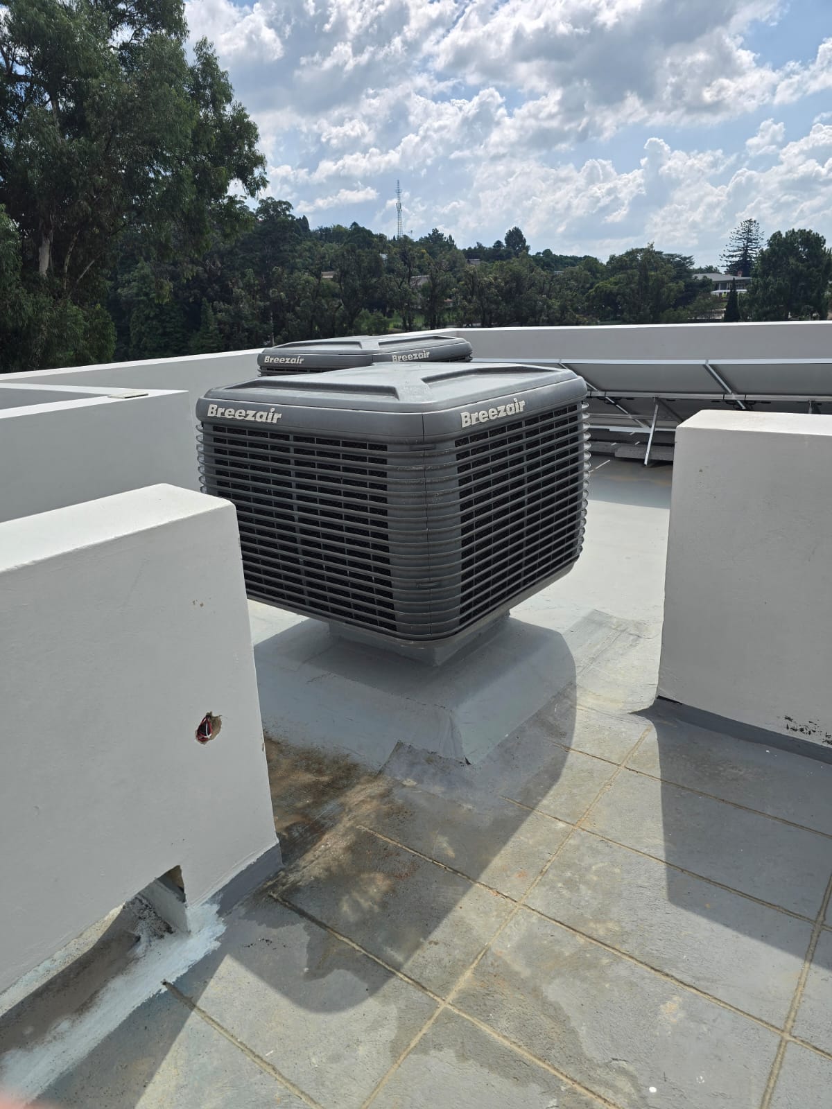 Breezeair evaporative cooler installed on commercial rooftop — Airtech Services